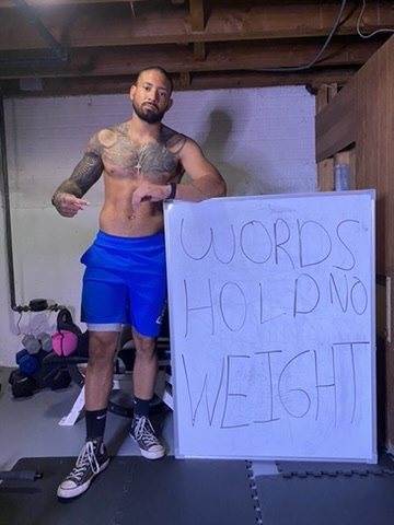 Eddie beside a whiteboard that reads Words hold no weight